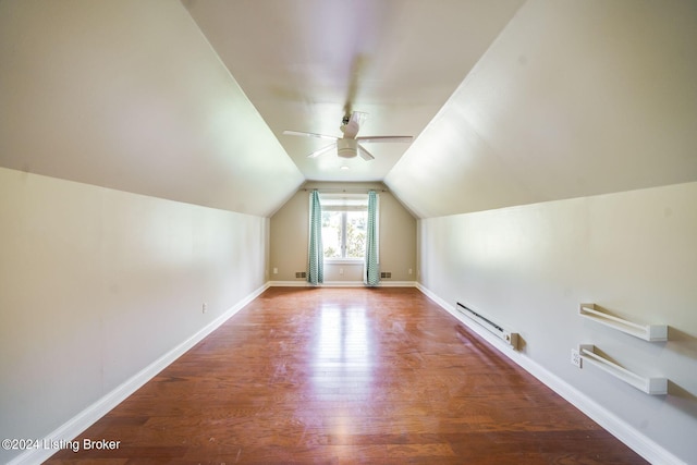 additional living space featuring ceiling fan, a baseboard heating unit, hardwood / wood-style flooring, and lofted ceiling