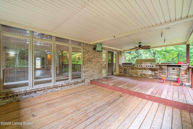 wooden terrace featuring ceiling fan, a grill, and exterior kitchen