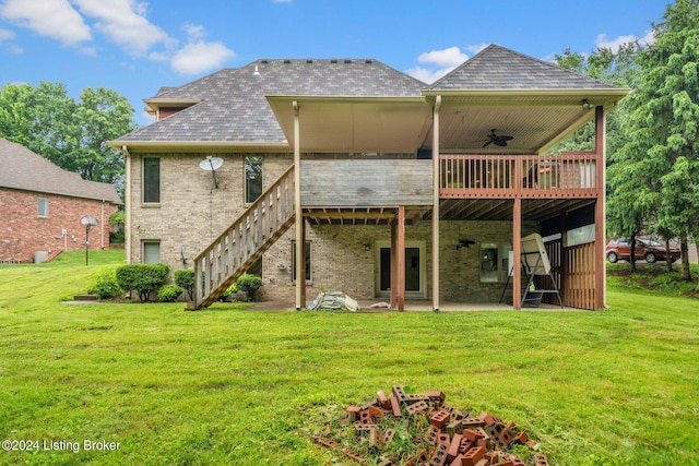 back of property with a wooden deck, a patio, and a yard