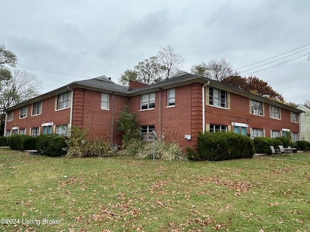 view of side of property with a lawn