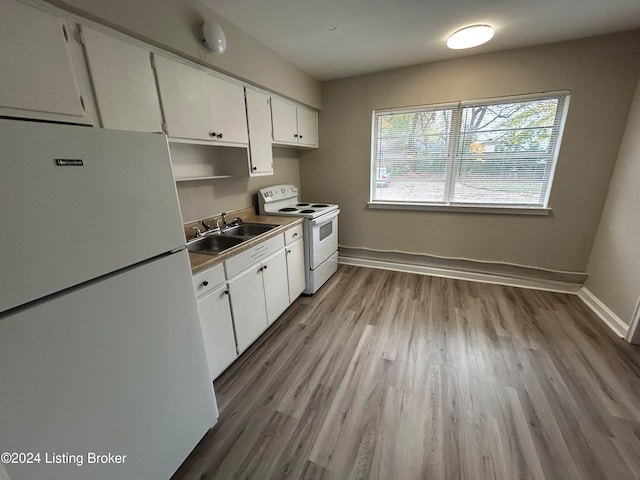 kitchen with white cabinetry, light hardwood / wood-style flooring, sink, and white appliances