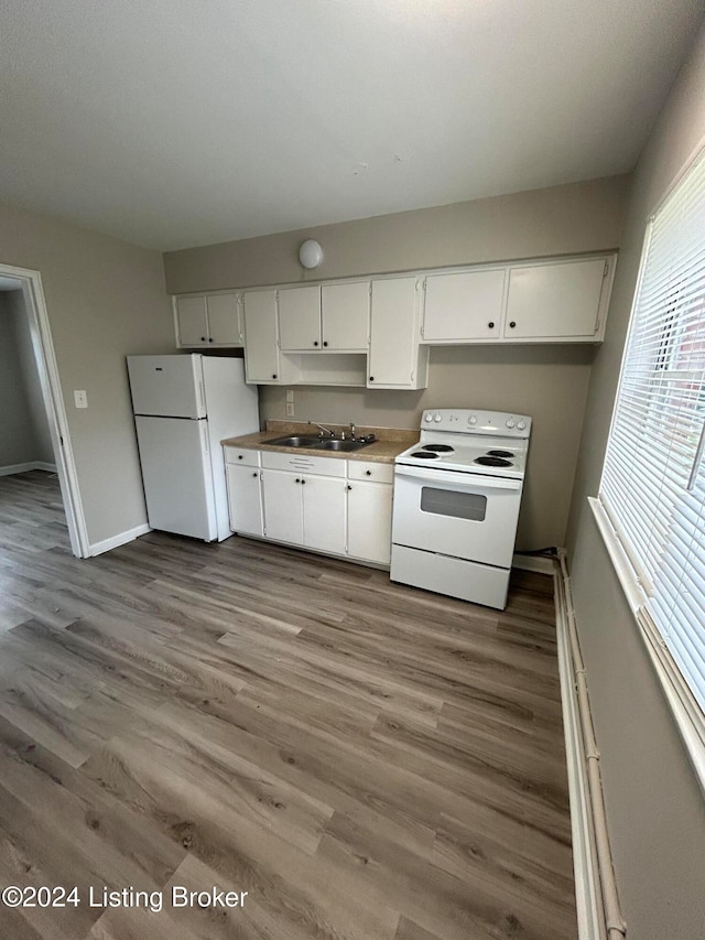 kitchen featuring hardwood / wood-style floors, white appliances, white cabinetry, and sink