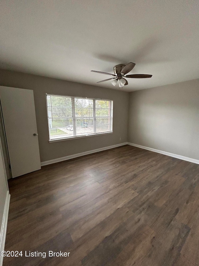 spare room with ceiling fan and dark hardwood / wood-style floors