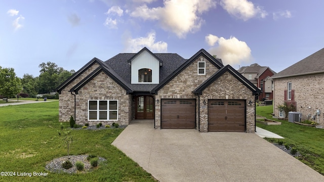 view of front of property featuring central AC, french doors, a front lawn, and a garage