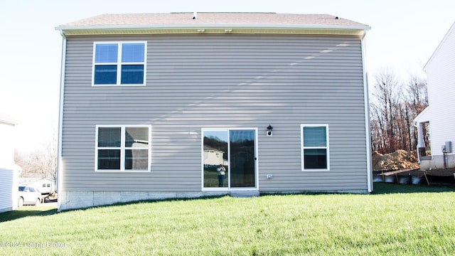 back of house featuring a yard