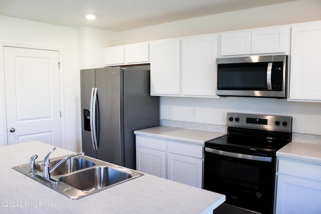 kitchen featuring white cabinets, appliances with stainless steel finishes, and sink