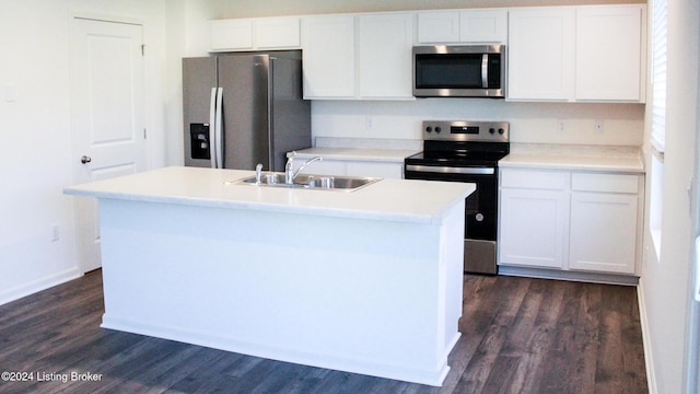 kitchen featuring a kitchen island with sink, white cabinetry, sink, and appliances with stainless steel finishes