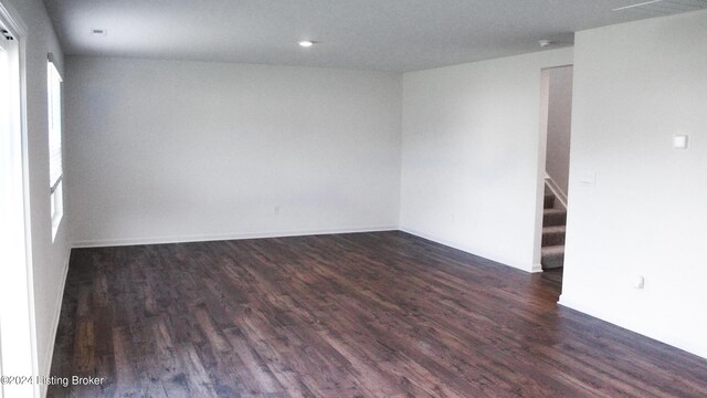 empty room with dark hardwood / wood-style floors