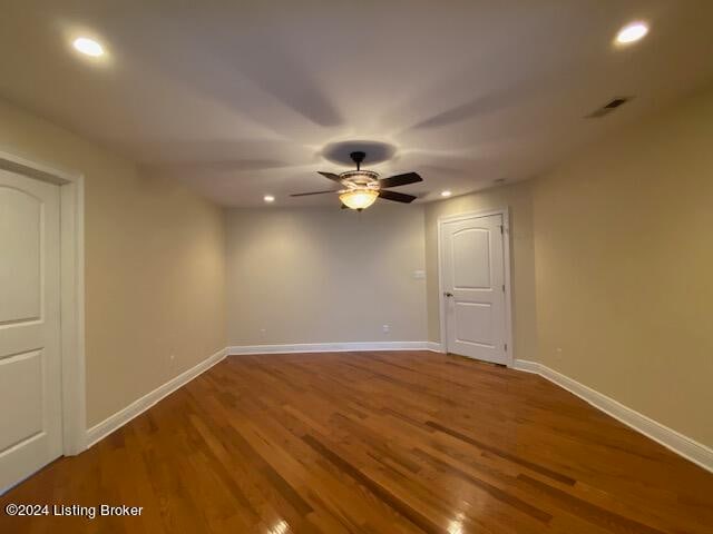 empty room with ceiling fan and wood-type flooring