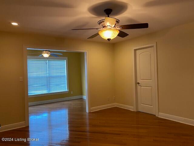 empty room featuring dark hardwood / wood-style floors and ceiling fan