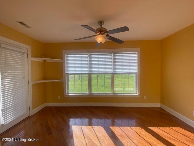 empty room with ceiling fan and hardwood / wood-style floors