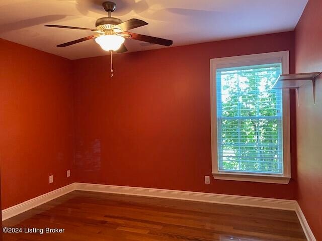 unfurnished room featuring ceiling fan and wood-type flooring