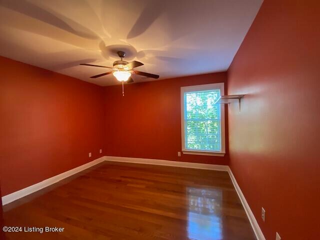 empty room featuring ceiling fan and hardwood / wood-style floors