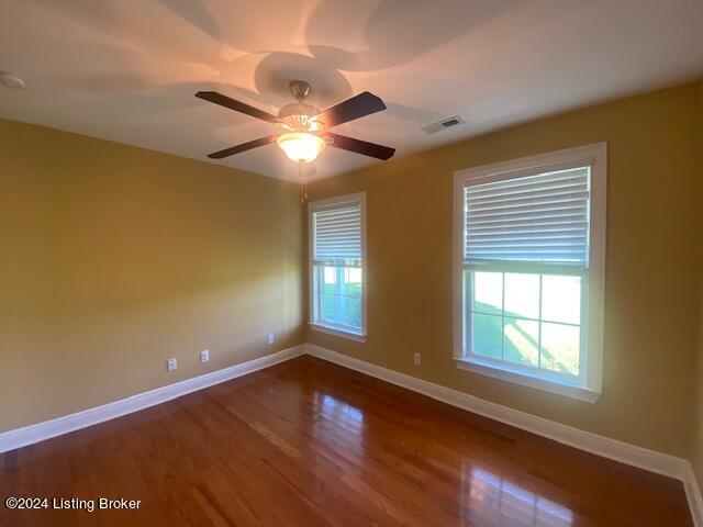 unfurnished room featuring ceiling fan and hardwood / wood-style floors