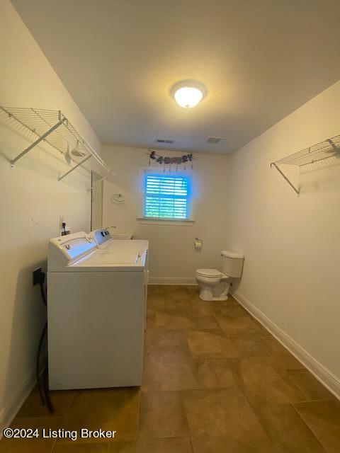 laundry room with washer and clothes dryer and tile floors