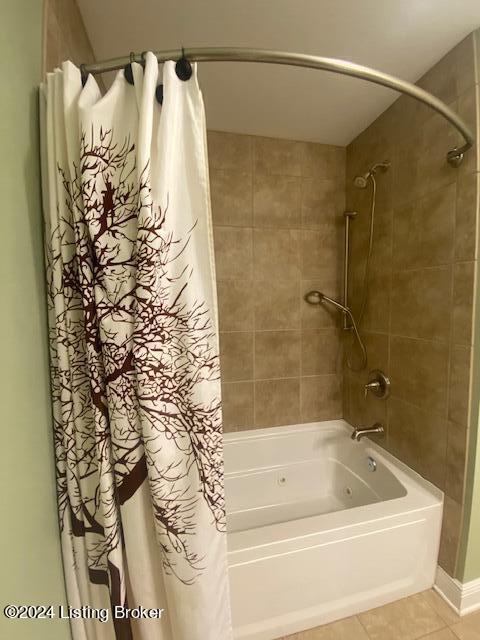 bathroom with tile flooring and shower / bath combo