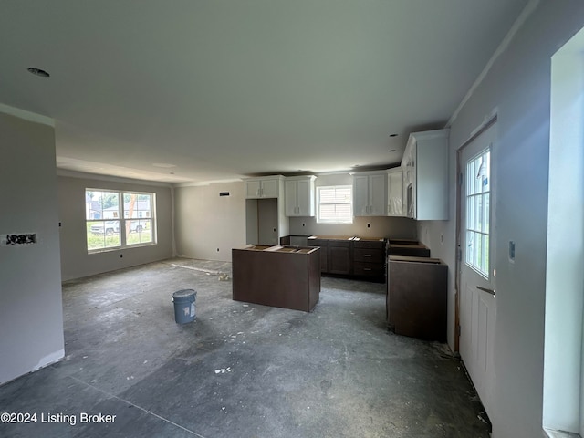 kitchen featuring white cabinets, plenty of natural light, and a center island