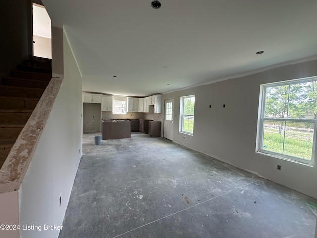 unfurnished living room with concrete floors