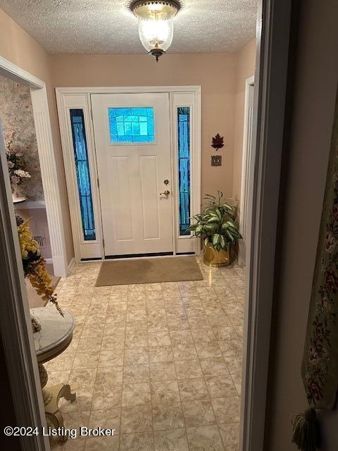 entryway with a textured ceiling