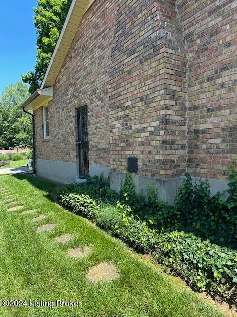 view of side of home featuring a lawn