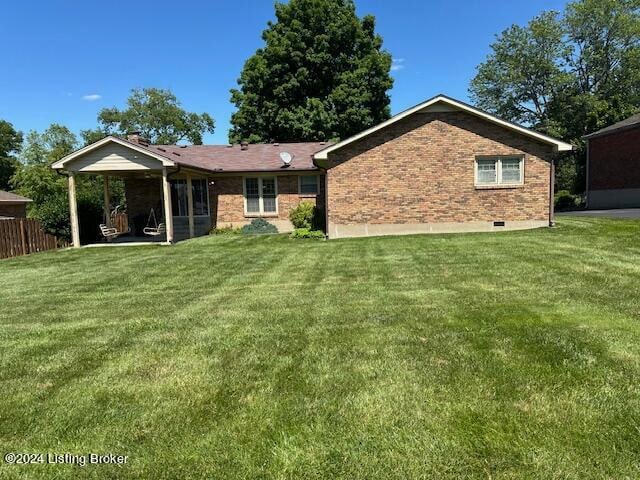 rear view of house with a yard