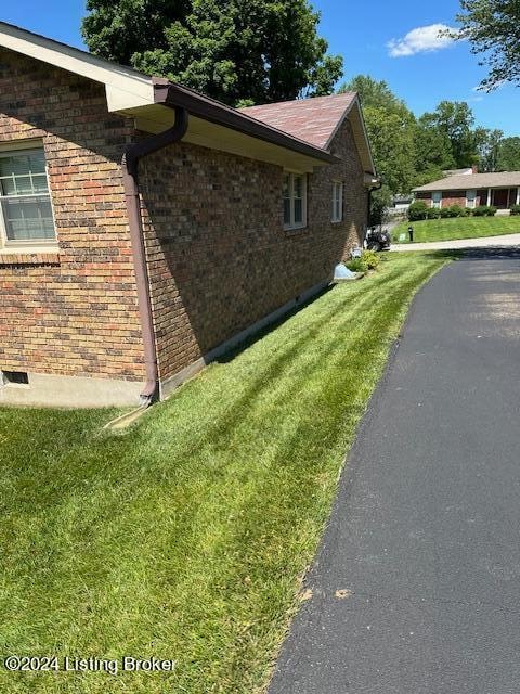 view of side of property with a yard