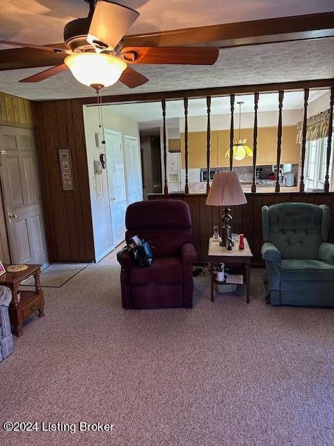 living room featuring wooden walls and carpet floors