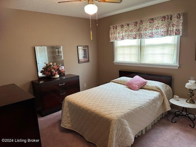 carpeted bedroom with ceiling fan