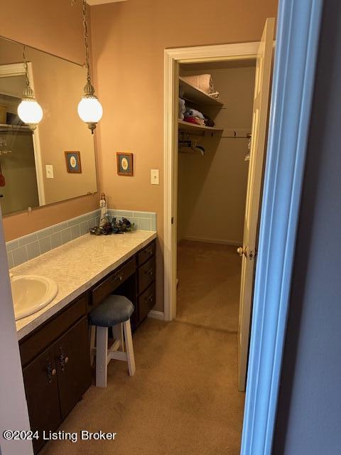 bathroom with tasteful backsplash and vanity