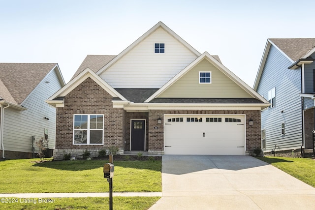 craftsman inspired home featuring concrete driveway, a front yard, brick siding, a garage, and a shingled roof