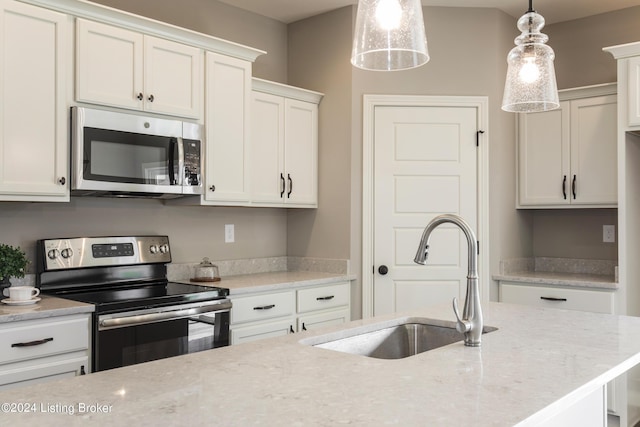 kitchen with pendant lighting, sink, stainless steel appliances, light stone counters, and white cabinets