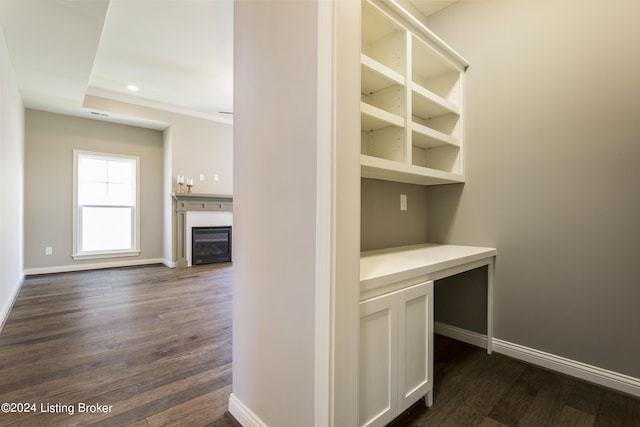 interior space with crown molding and dark hardwood / wood-style flooring