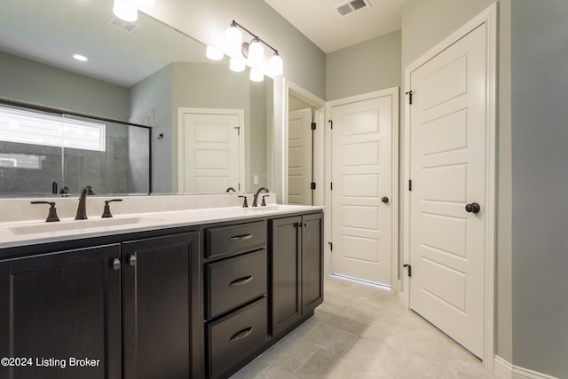 bathroom with vanity, tile patterned flooring, and walk in shower