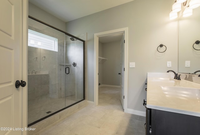 bathroom with vanity and a shower with shower door