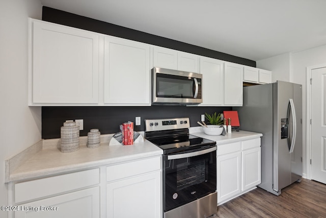 kitchen featuring dark hardwood / wood-style floors, white cabinetry, and stainless steel appliances