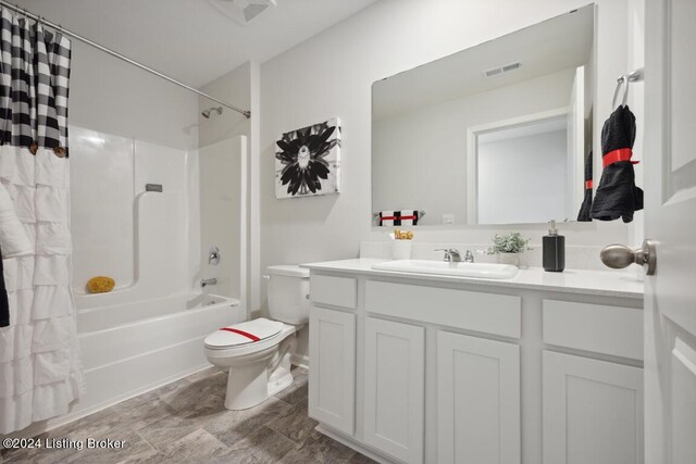 full bathroom featuring shower / bath combo with shower curtain, vanity, and toilet