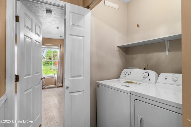 136 Beechtree Ln, Mt Washington, KY 40047 - laundry room with separate washer and dryer, laundry area, light wood-type flooring, and a textured ceiling