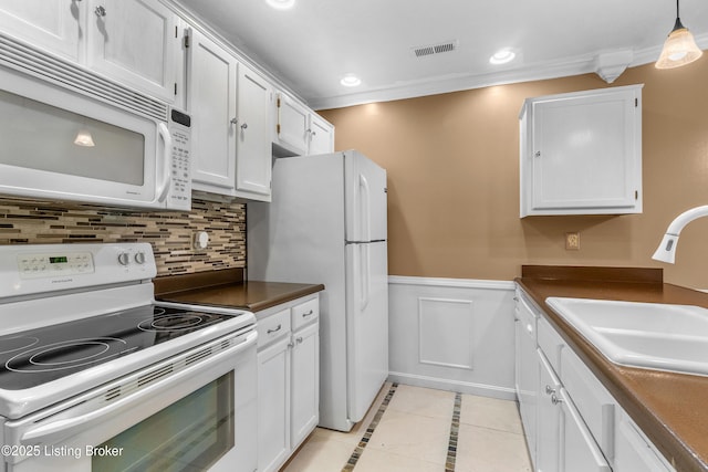 136 Beechtree Ln, Mt Washington, KY 40047 - kitchen featuring dark countertops, wainscoting, a sink, white appliances, and white cabinetry
