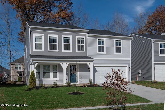 view of front of house with a front lawn and a garage