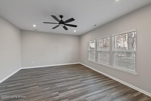 unfurnished room with dark hardwood / wood-style floors and ceiling fan