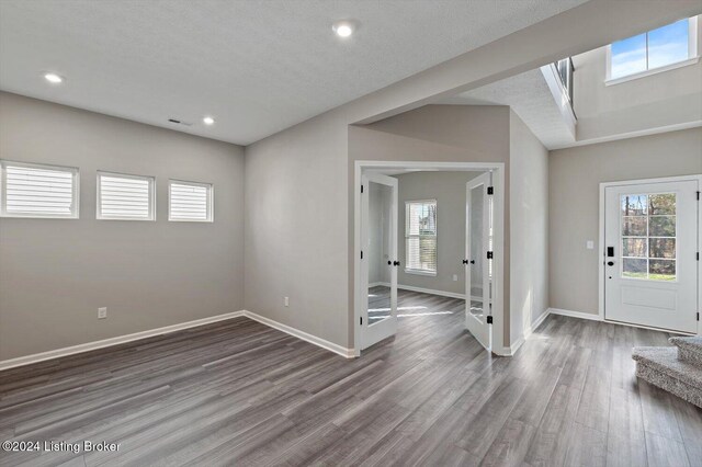 entrance foyer with wood-type flooring and a textured ceiling