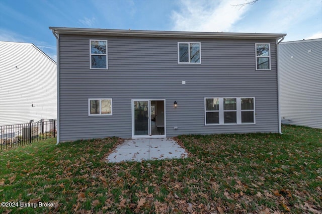 rear view of property featuring a patio area and a yard