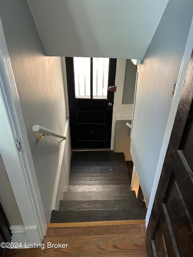 stairs featuring wood-type flooring