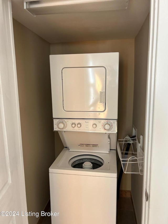 washroom with tile patterned floors and stacked washer / dryer