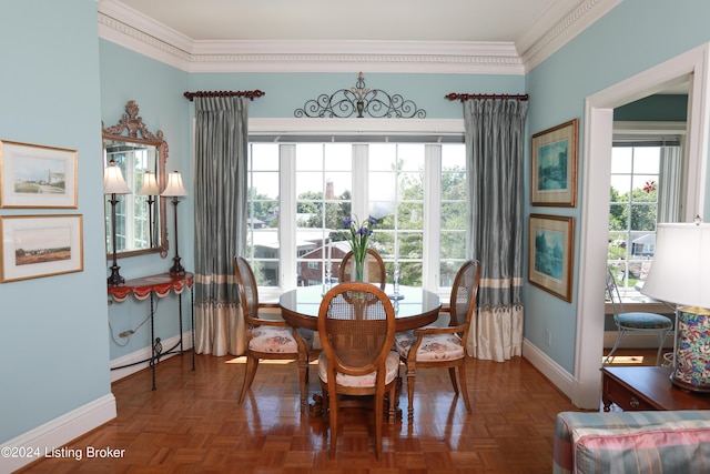 dining space featuring dark parquet floors and crown molding