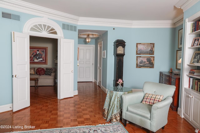 living area with dark parquet floors and ornamental molding