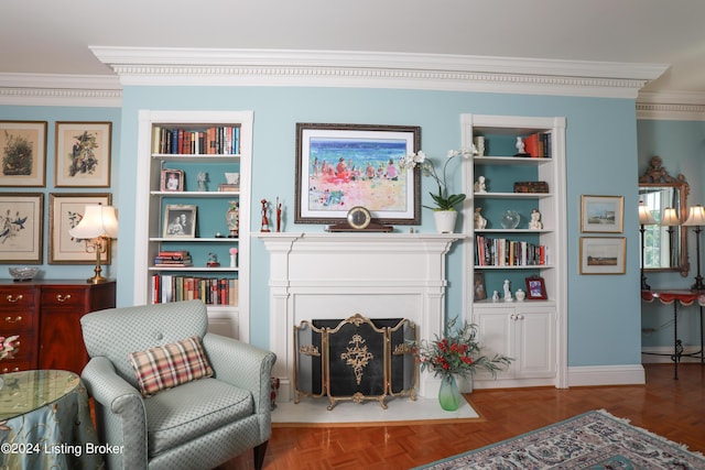 sitting room with built in shelves, parquet flooring, and crown molding