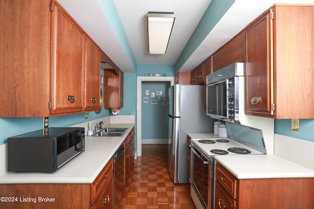 kitchen with black appliances, dark parquet floors, and sink