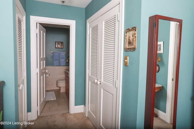 corridor with light tile patterned flooring