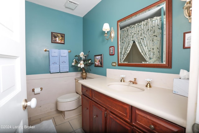 bathroom featuring tile patterned floors, vanity, and toilet